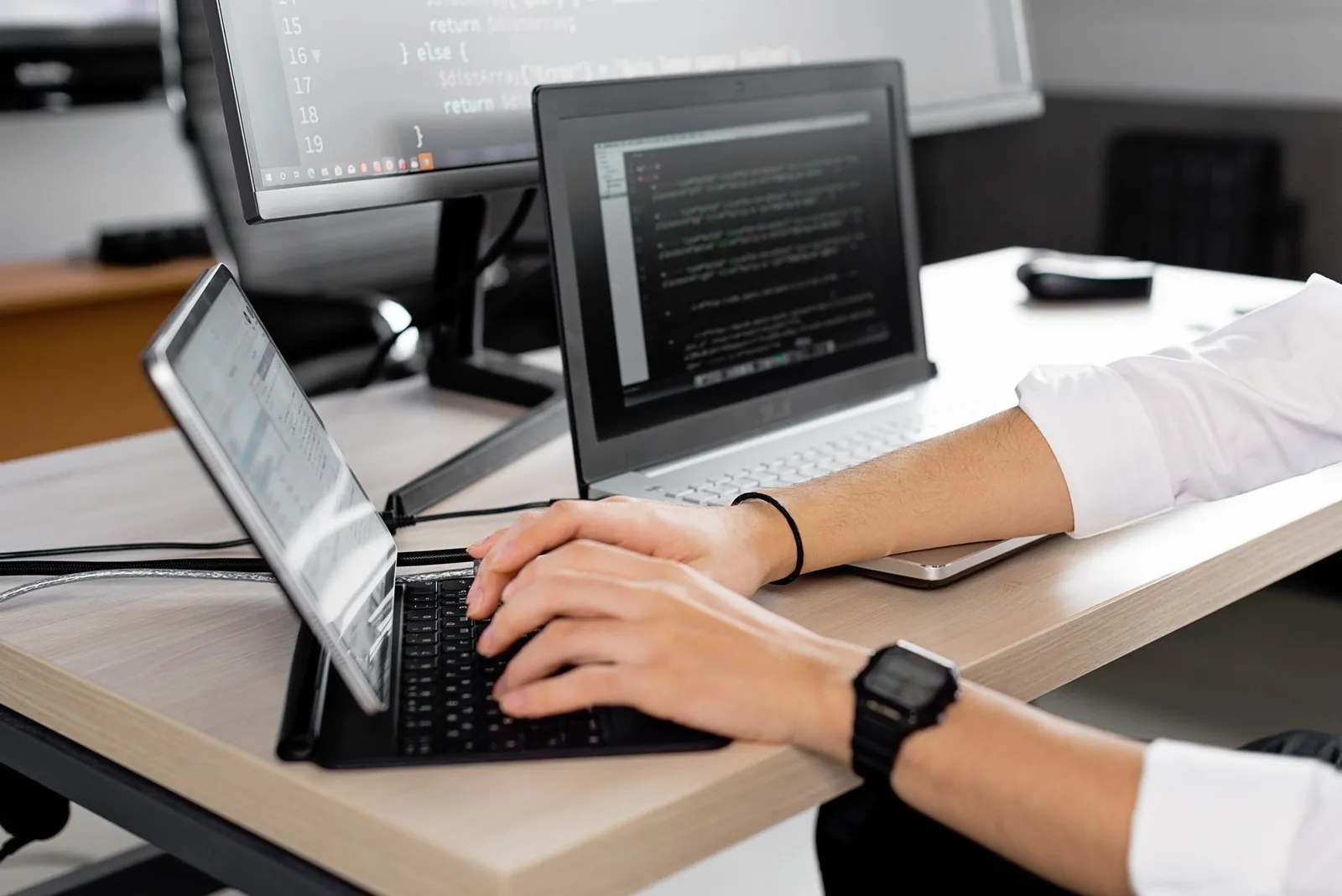 Developer typing on a tablet keyboard with code on screen, preparing for the AWS generative AI developer exam